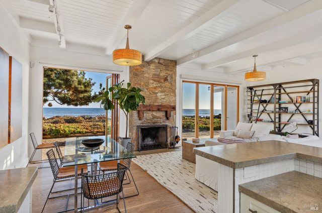 a living room with fireplace furniture and a floor to ceiling window