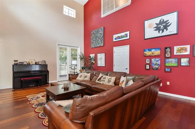 a view of a patio with table and chairs under an umbrella with wooden floor