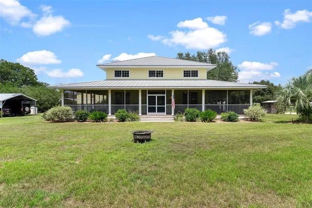an aerial view of residential house with outdoor space and swimming pool