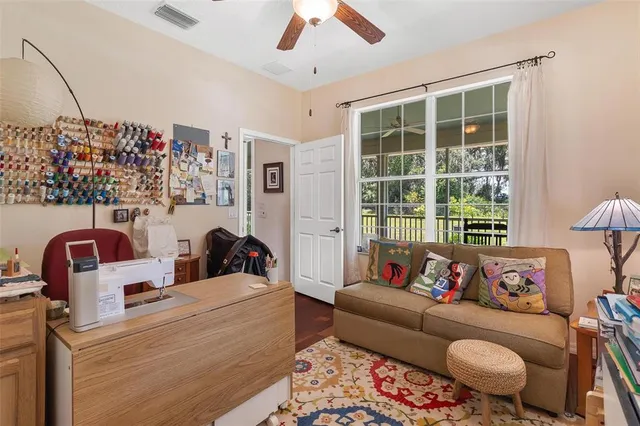 a view of a house with a yard and large tree