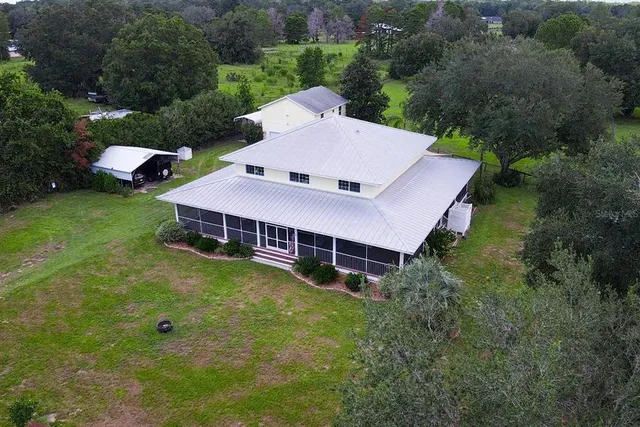 a view of a hallway with wooden floor and a living room