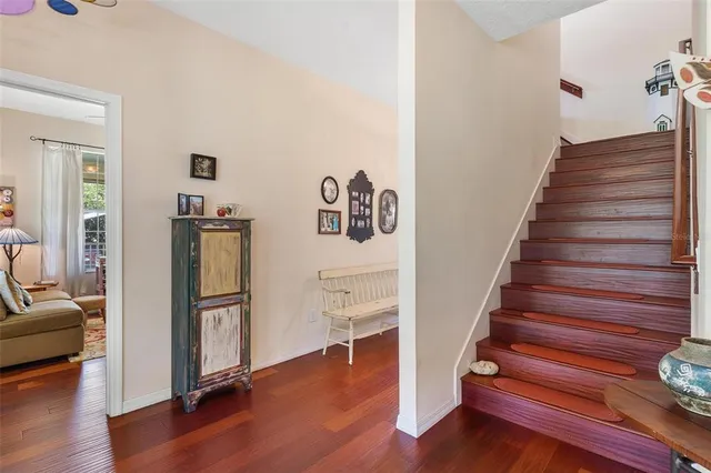 a bathroom with a granite countertop double vanity sink a toilet and a mirror
