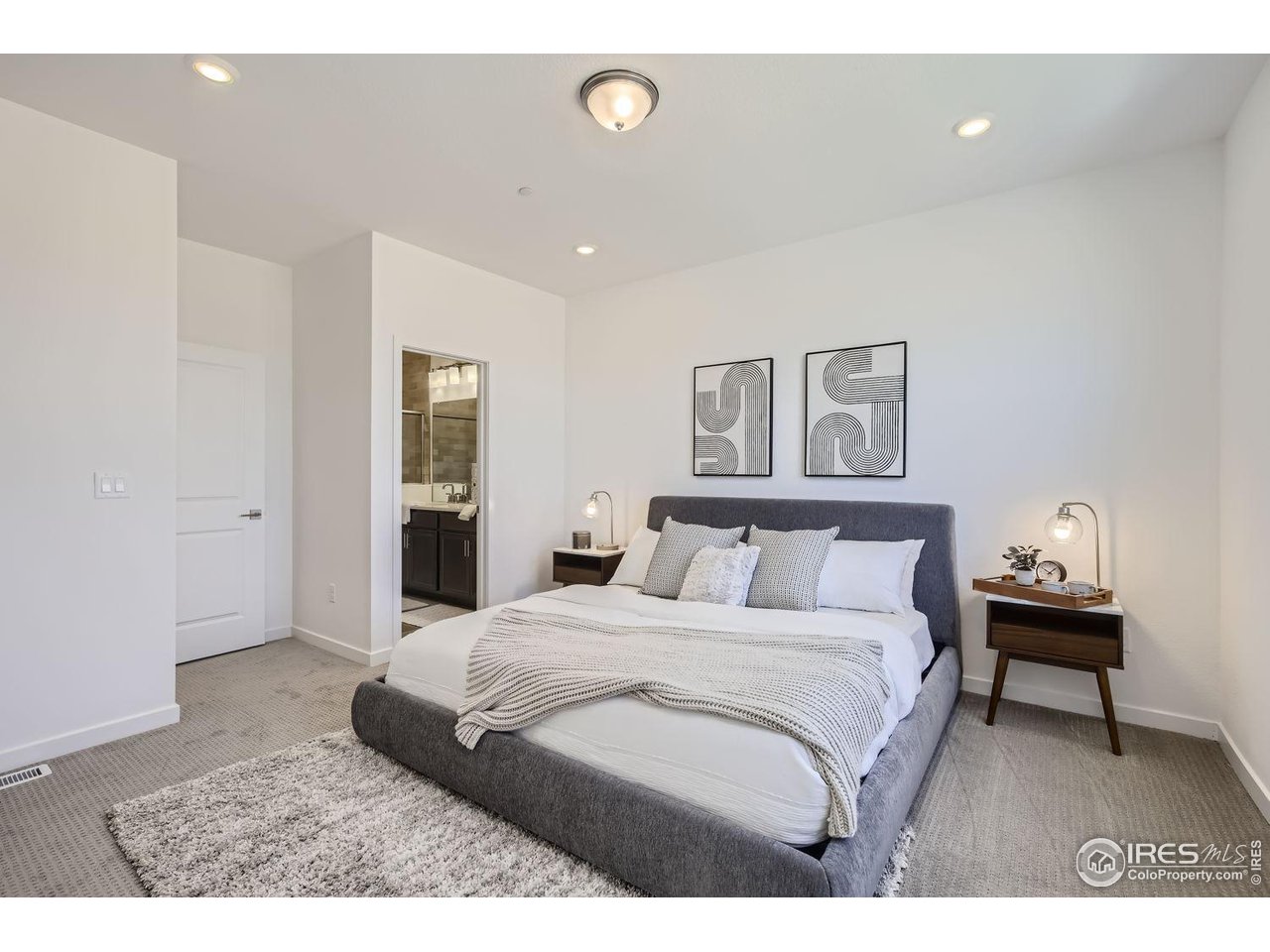 2721 Bear Springs Circle Longmont, CO 80503 - Photo 16 of 27 a bedroom with a bed and a painting on the wall