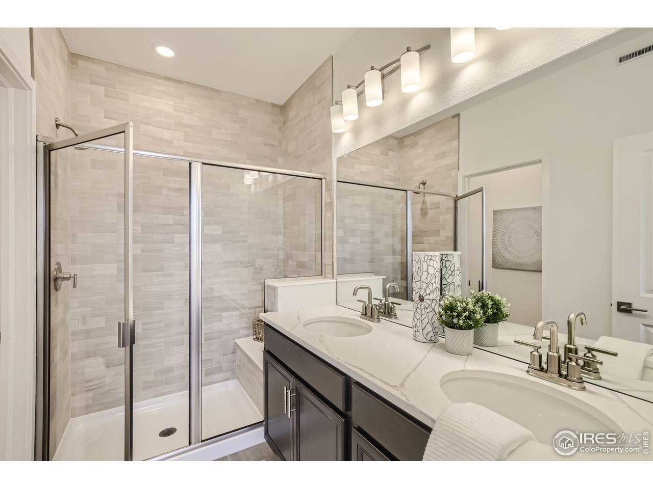 2721 Bear Springs Circle Longmont, CO 80503 - Photo 18 of 27 a bathroom with a double vanity sink mirror and shower