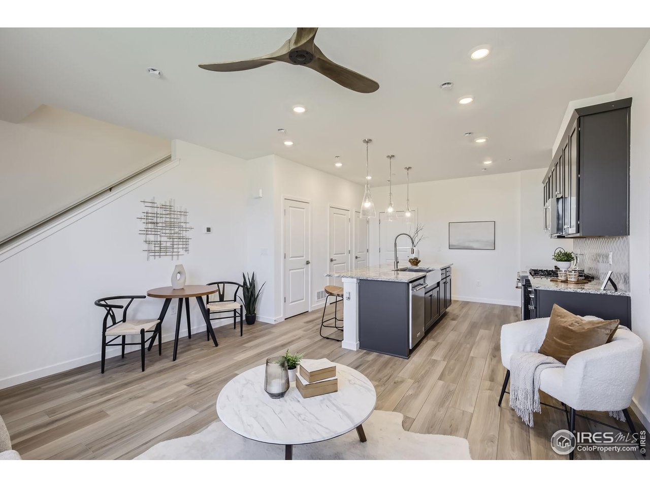 2721 Bear Springs Circle Longmont, CO 80503 - Photo 9 of 27 a kitchen with a dining table and chairs