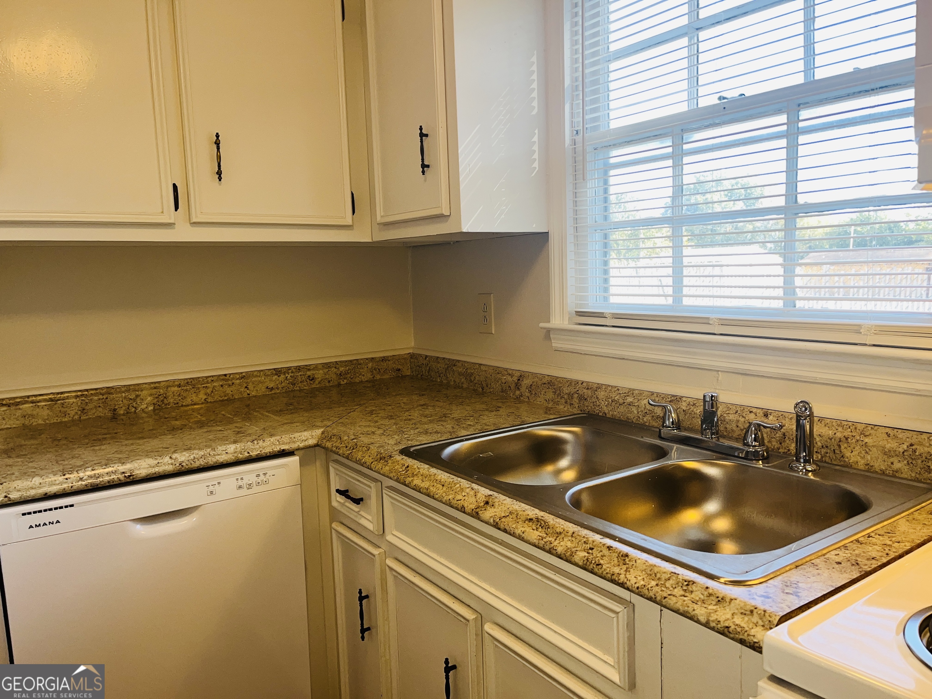 17 Curran Avenue, Unit A LaGrange, GA 30241 - Photo 11 of 25 a kitchen with granite countertop a sink and a white cabinets
