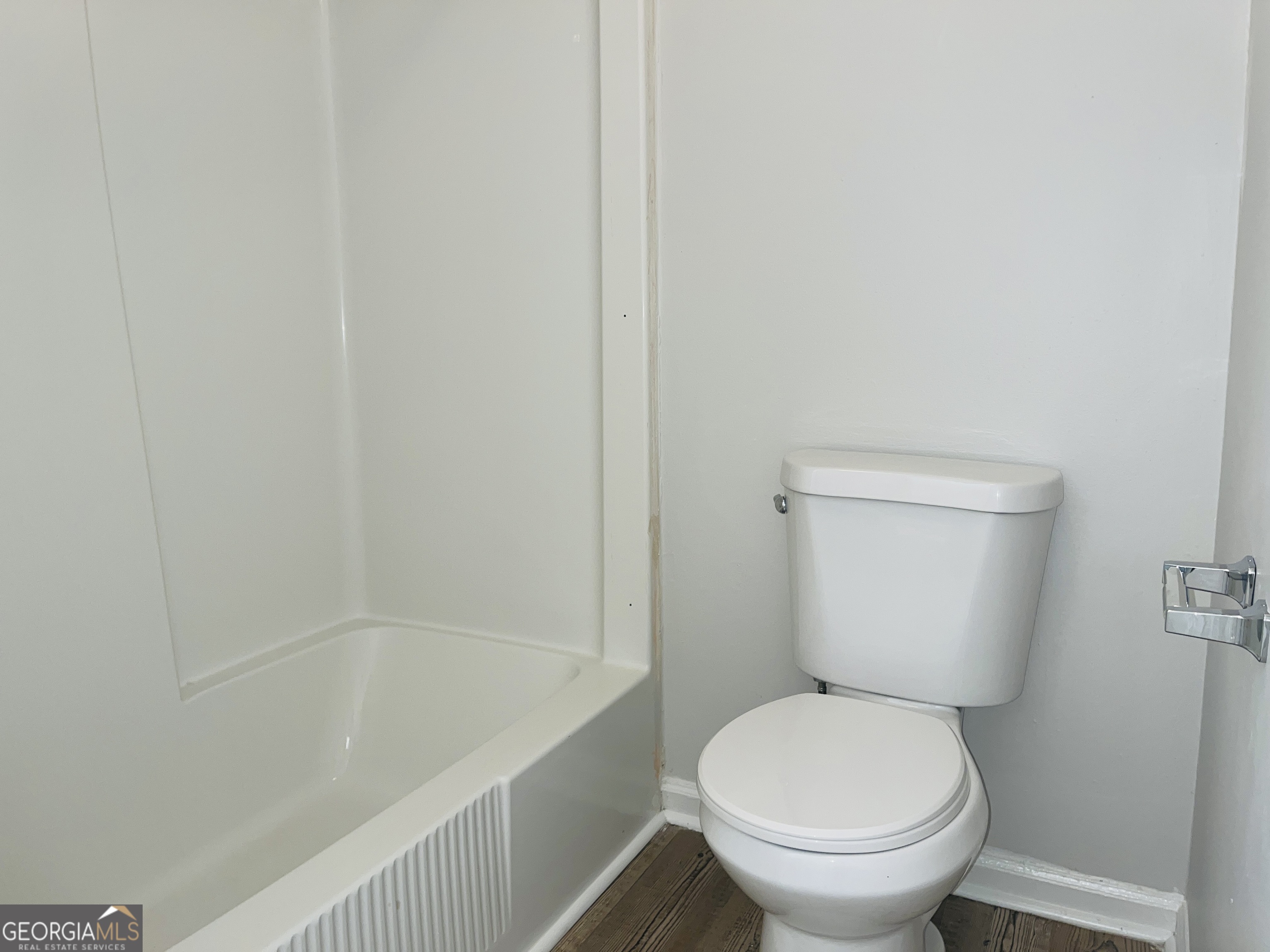 17 Curran Avenue, Unit A LaGrange, GA 30241 - Photo 18 of 25 a white toilet sitting next to a bath tub