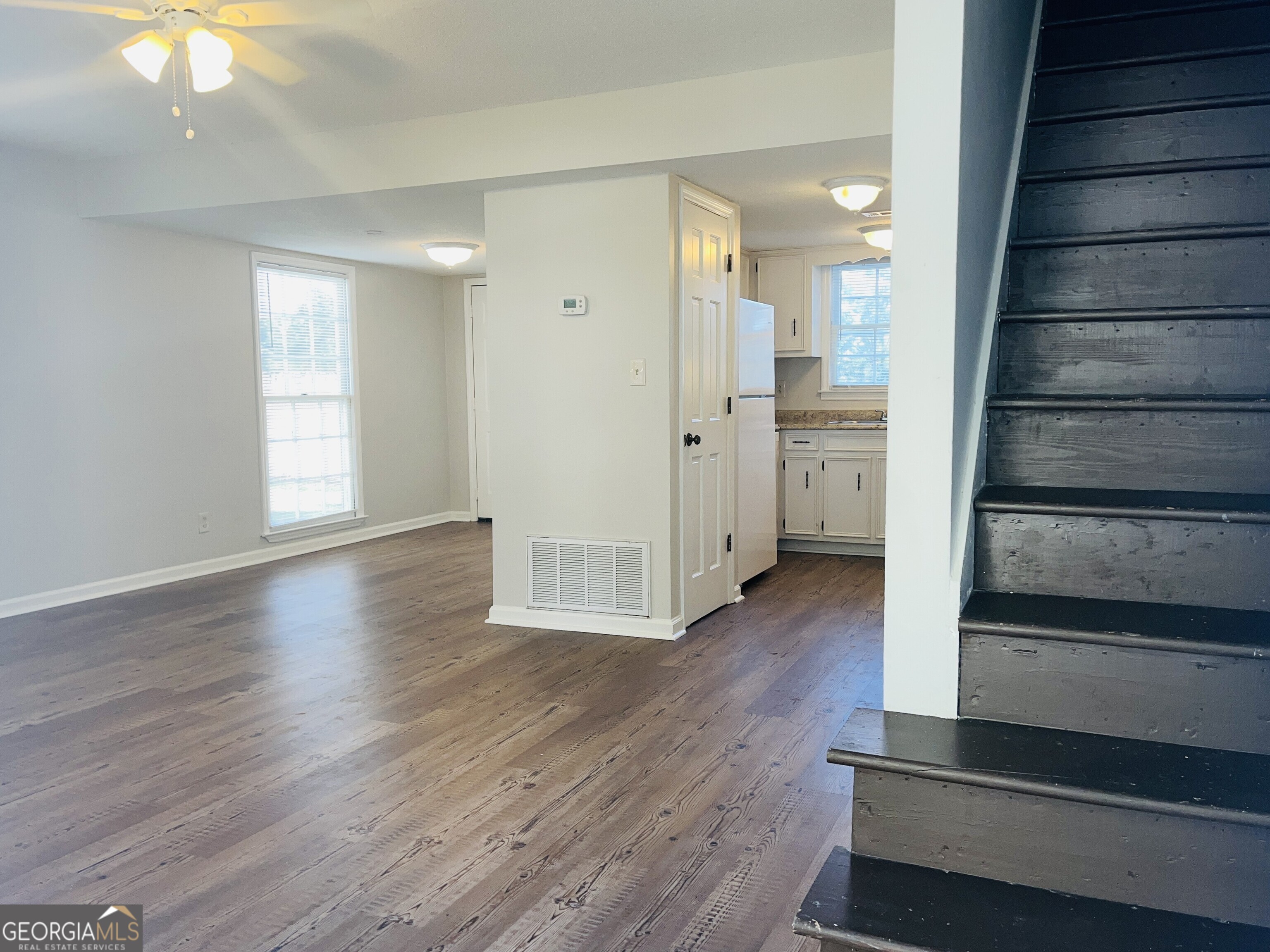17 Curran Avenue, Unit A LaGrange, GA 30241 - Photo 4 of 25 a view of a hallway with wooden floor and staircase