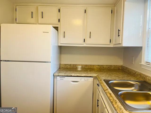 a white refrigerator freezer sitting inside of a kitchen