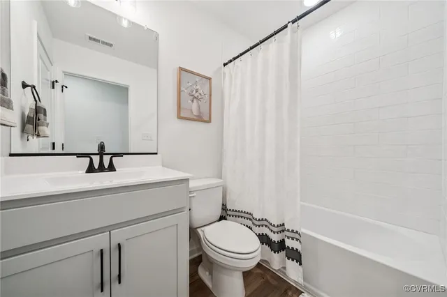 a view of a house with a big yard and large trees