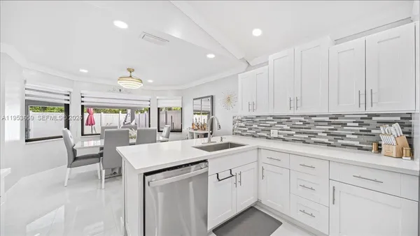 a kitchen with sink and white cabinets