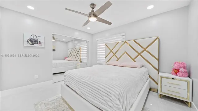 a bedroom with a bed a window and a chandelier