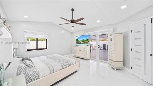 a bedroom with a bed dresser and a window