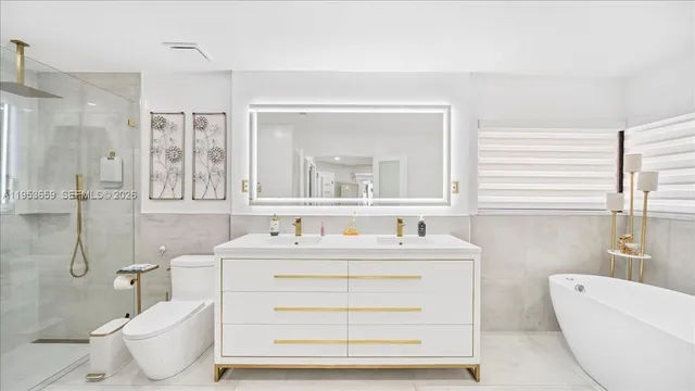 a bathroom with a double vanity sink mirror and toilet