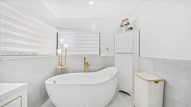 a bathroom with a sink a toilet and tub