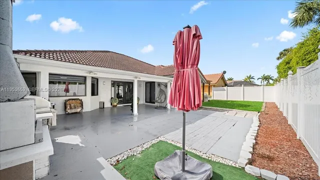 a front view of a house with a yard patio and fire pit