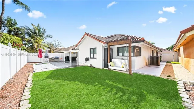 a view of a house with a yard and sitting area