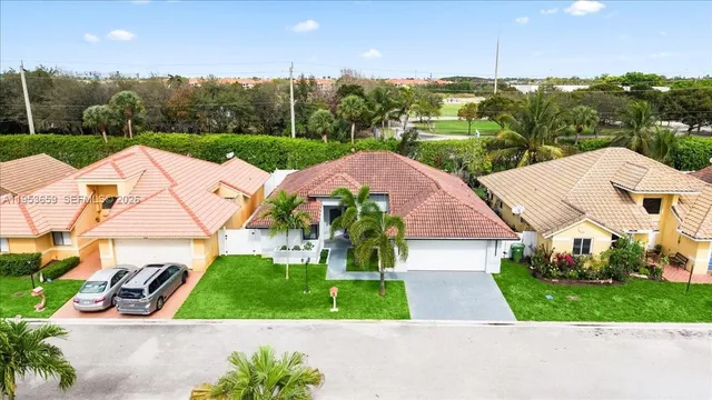 an aerial view of multiple houses with a yard