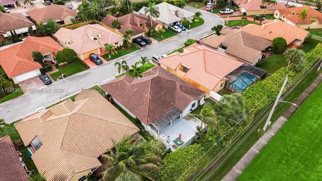 an aerial view of residential houses with outdoor space