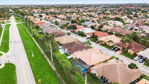 an aerial view of residential houses with outdoor space