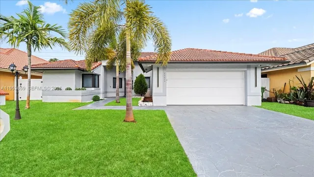 a front view of house with yard and green space