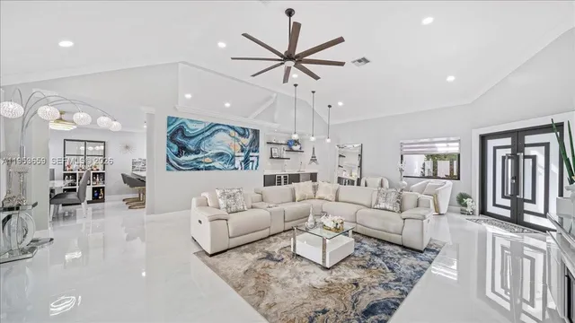 a living room with furniture a rug and a chandelier