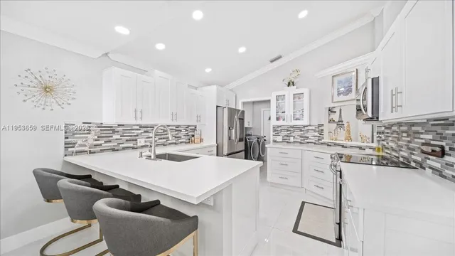 a kitchen with stainless steel appliances kitchen island granite countertop a sink and cabinets
