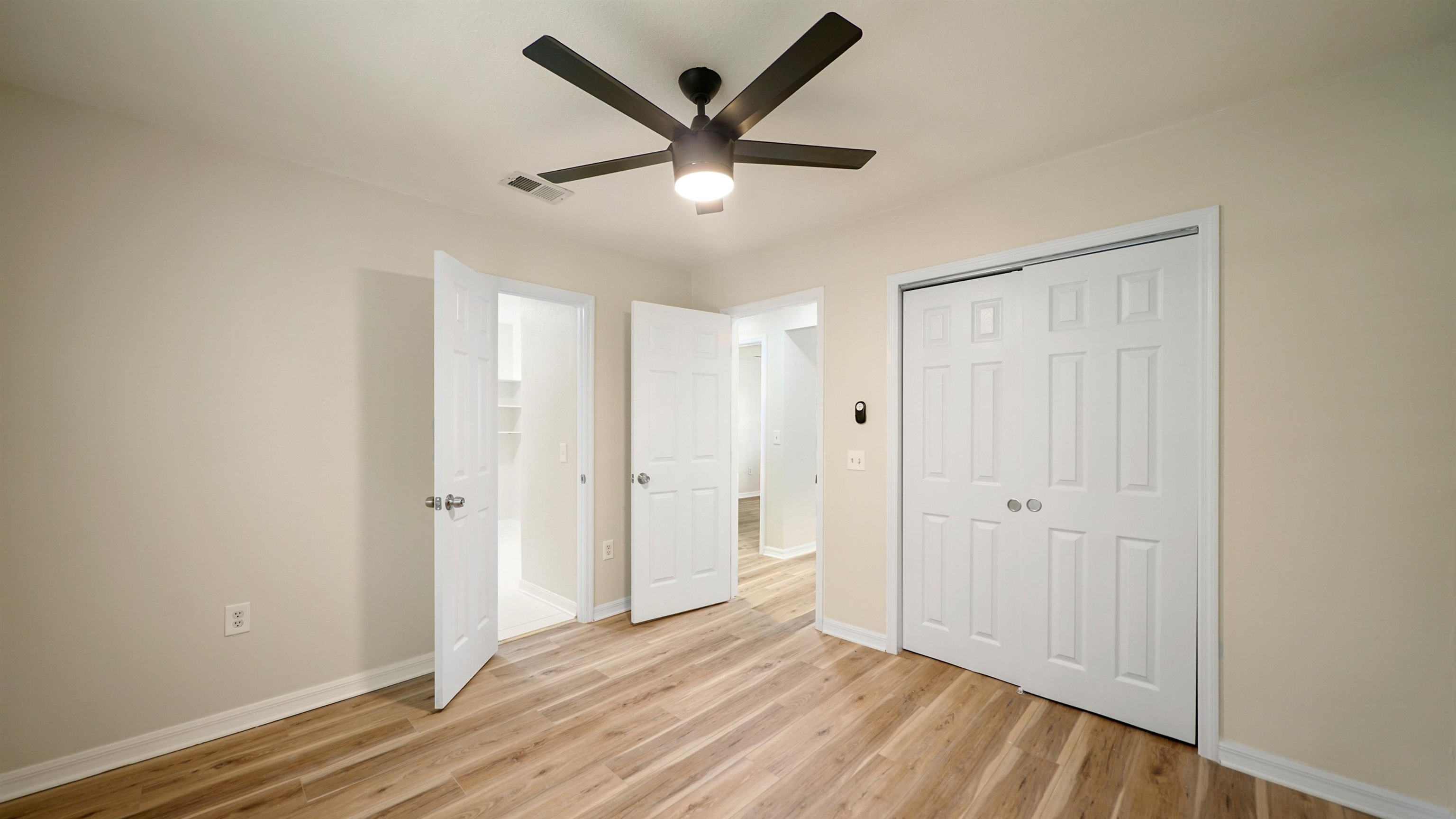 11734 Wynell Road Jacksonville, FL 32218 - Photo 11 of 27 an empty room to hallway with wooden floor