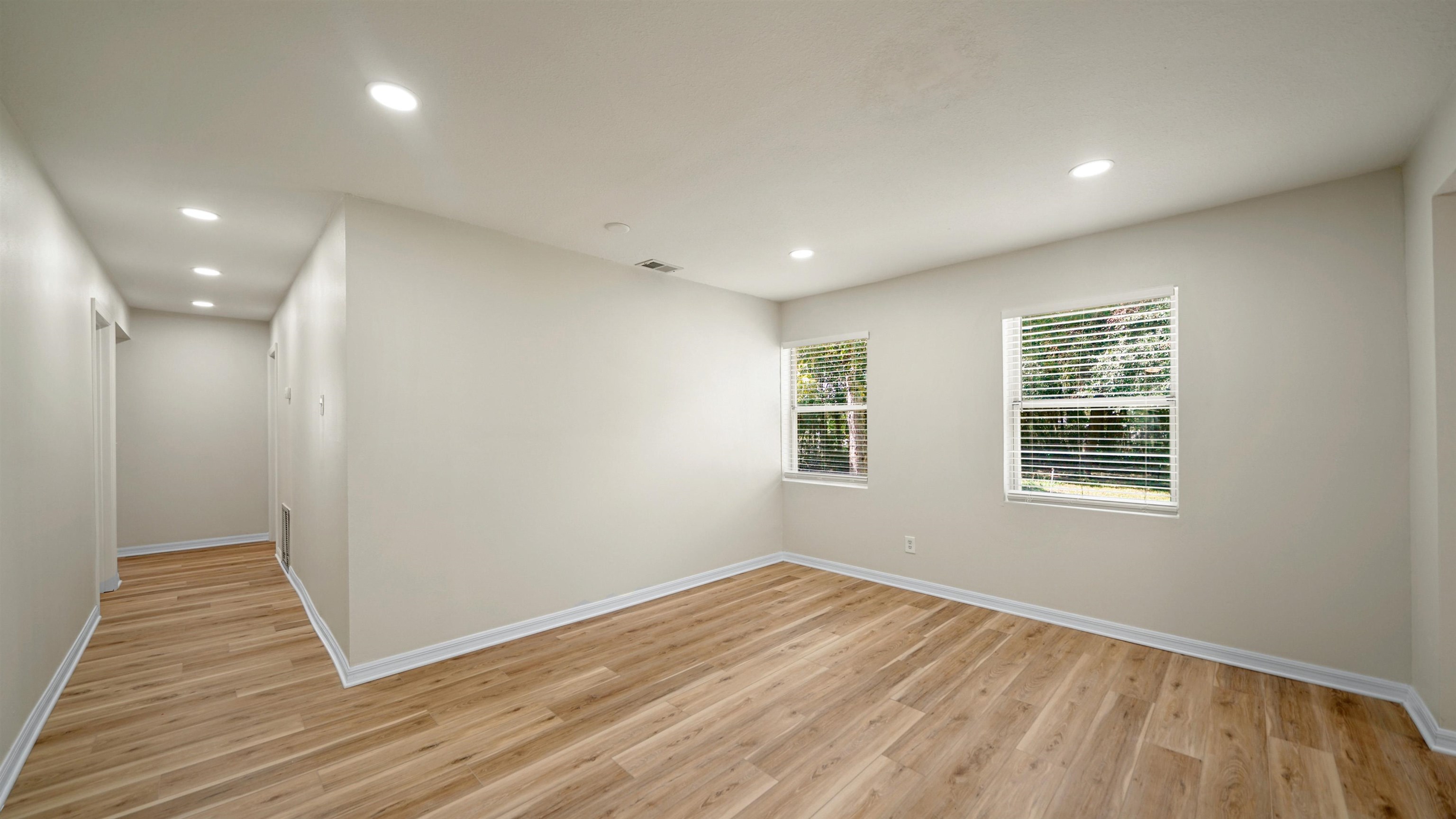 11734 Wynell Road Jacksonville, FL 32218 - Photo 12 of 27 a view of empty room with wooden floor and fan