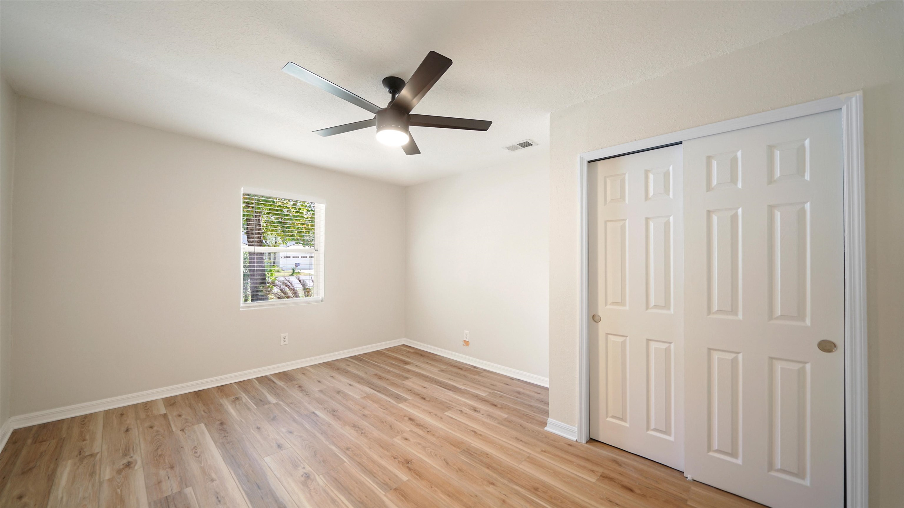 11734 Wynell Road Jacksonville, FL 32218 - Photo 14 of 27 a view of empty room with wooden floor and fan