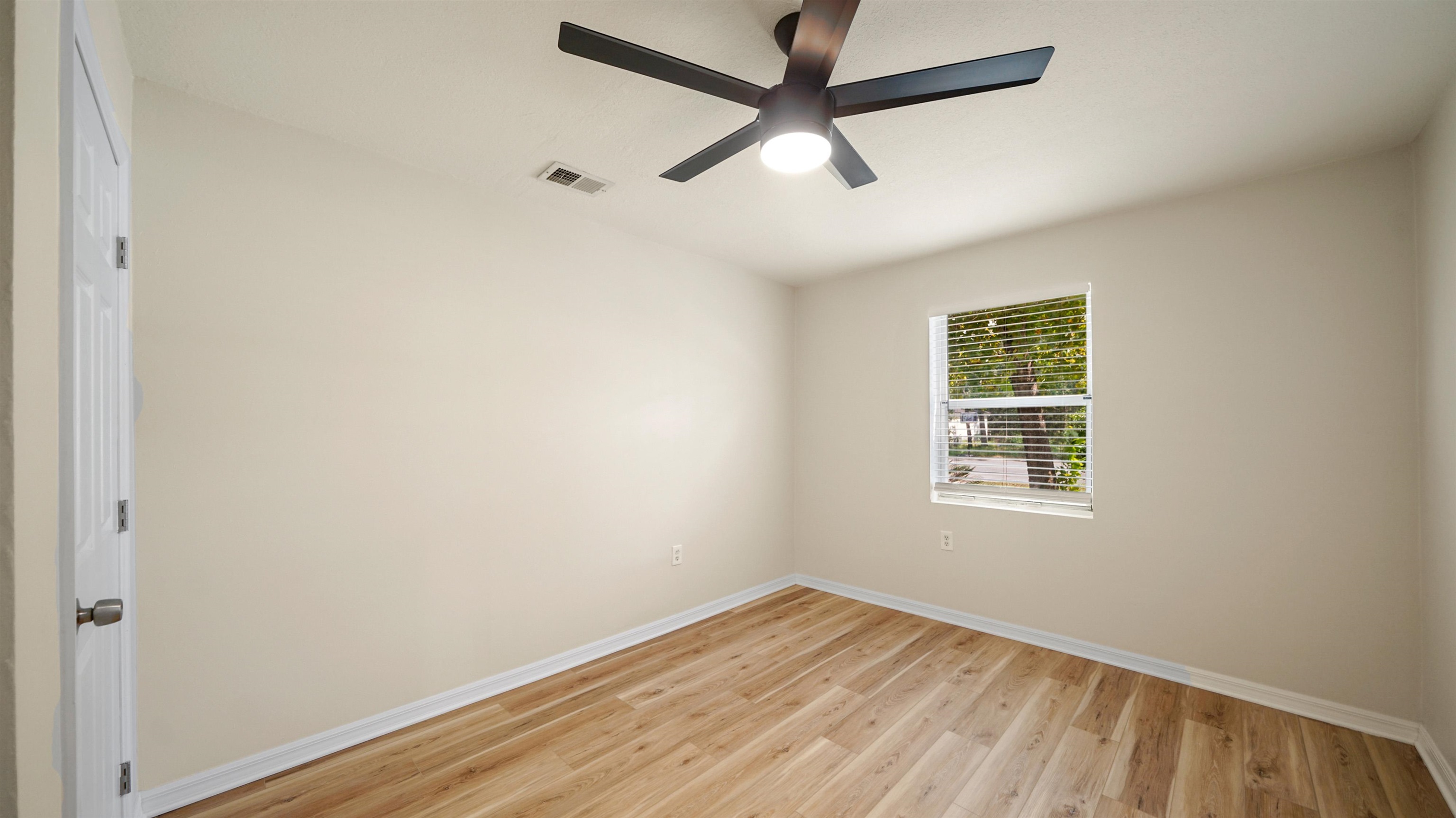 11734 Wynell Road Jacksonville, FL 32218 - Photo 18 of 27 an empty room with wooden floor and windows