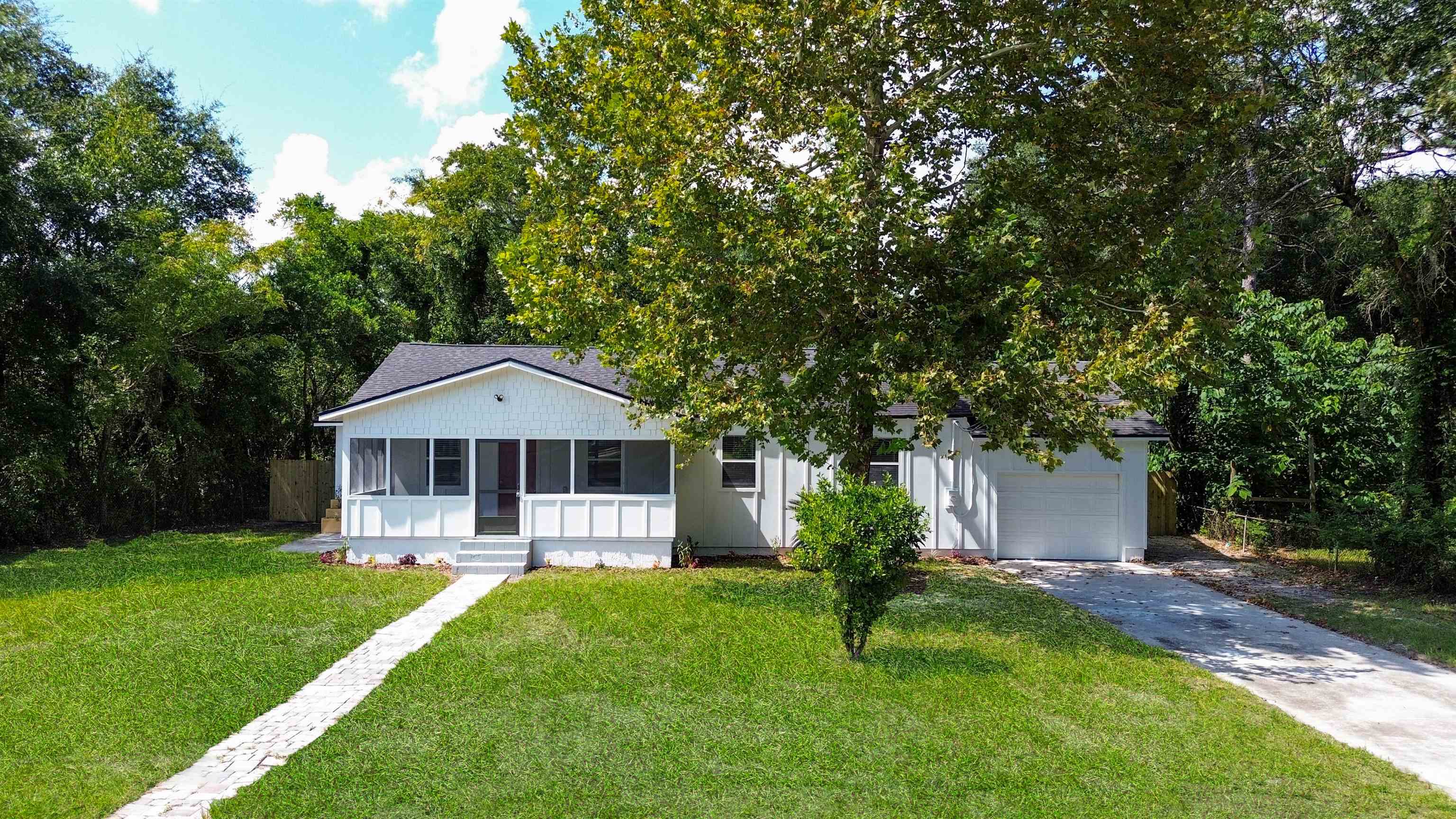 11734 Wynell Road Jacksonville, FL 32218 - Photo 25 of 27 a front view of a house with a yard and trees