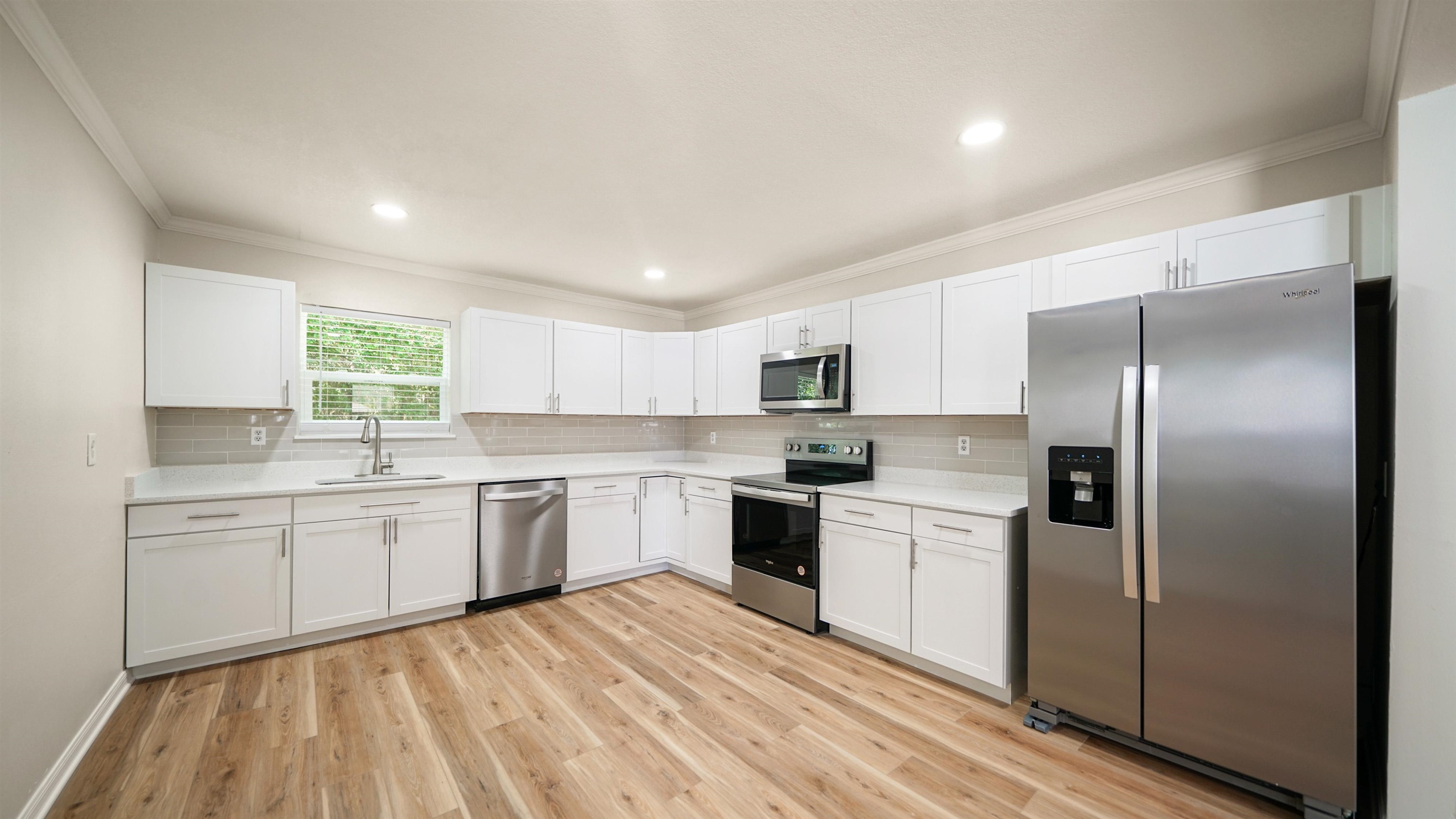 11734 Wynell Road Jacksonville, FL 32218 - Photo 4 of 27 a kitchen with white cabinets stainless steel appliances and sink