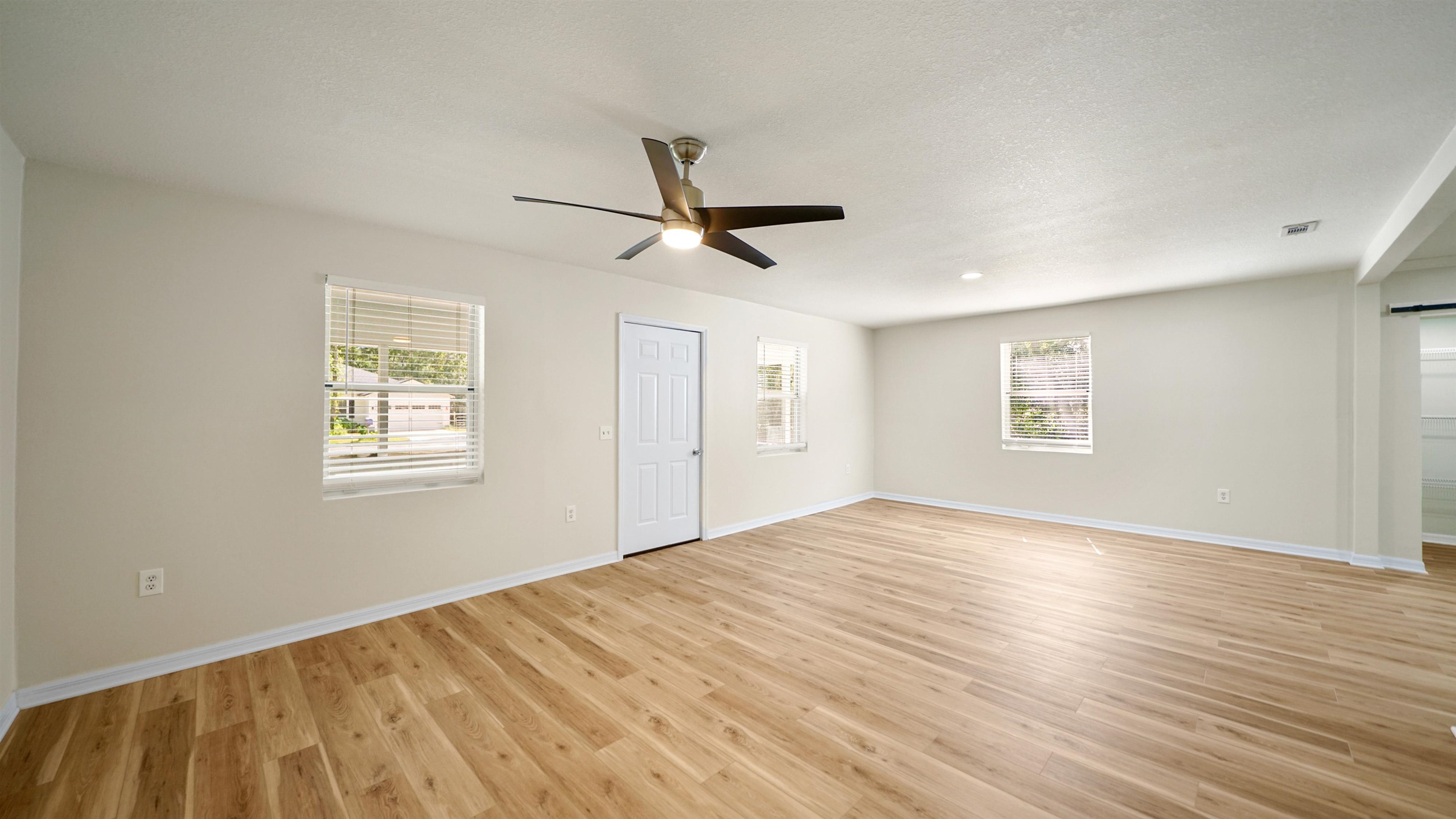 11734 Wynell Road Jacksonville, FL 32218 - Photo 6 of 27 a view of empty room with wooden floor and fan
