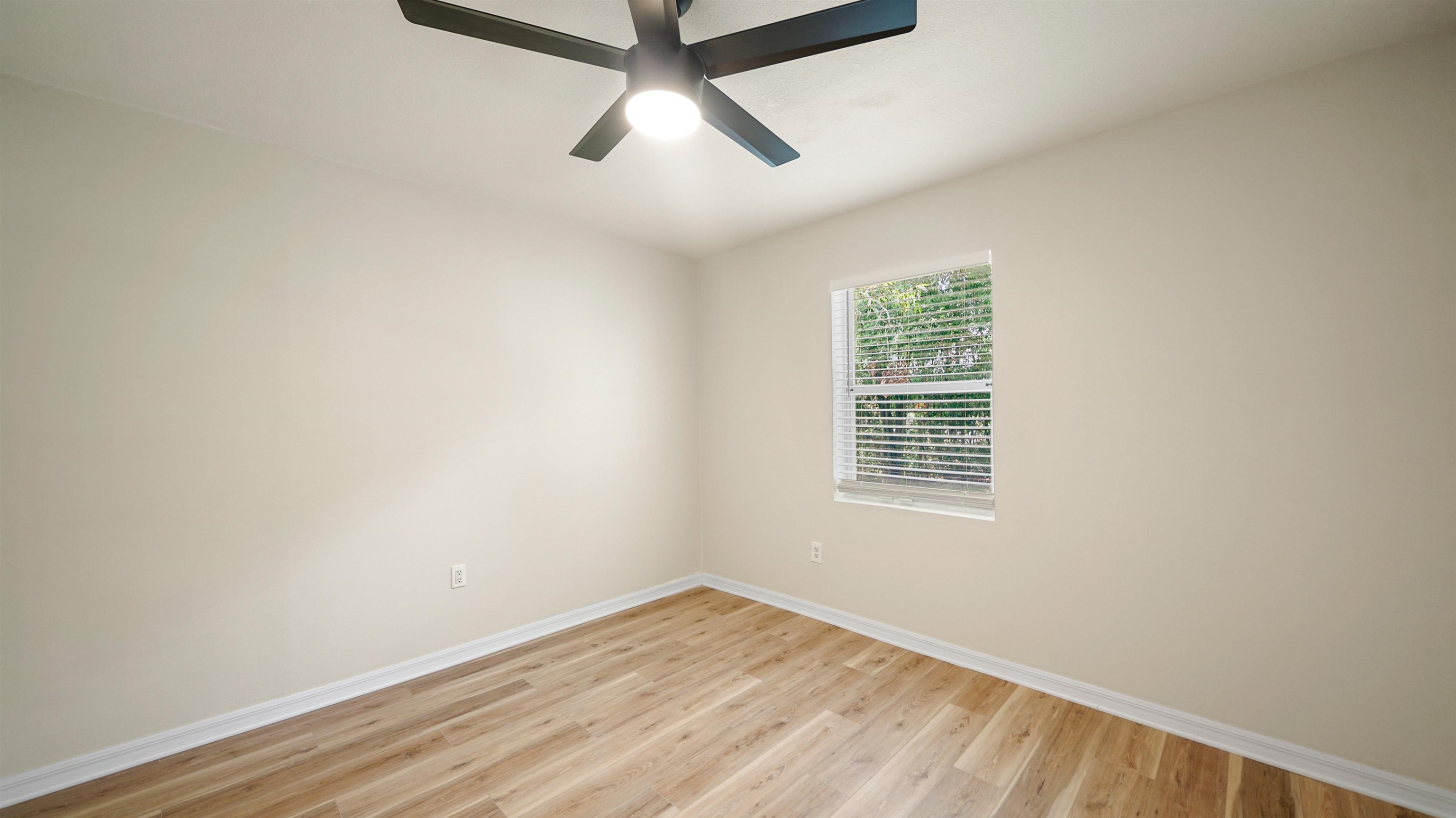 11734 Wynell Road Jacksonville, FL 32218 - Photo 8 of 27 an empty room with a window and a ceiling fan