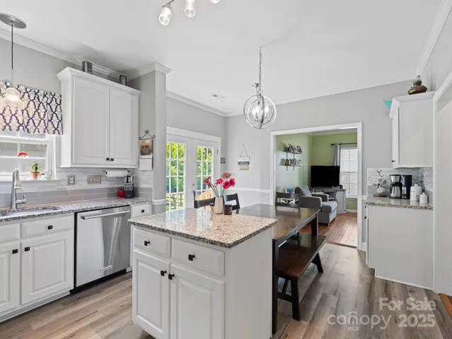 a open kitchen with sink cabinets and wooden floor