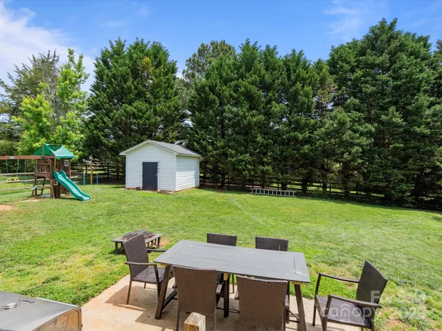 a view of a house with backyard porch and furniture