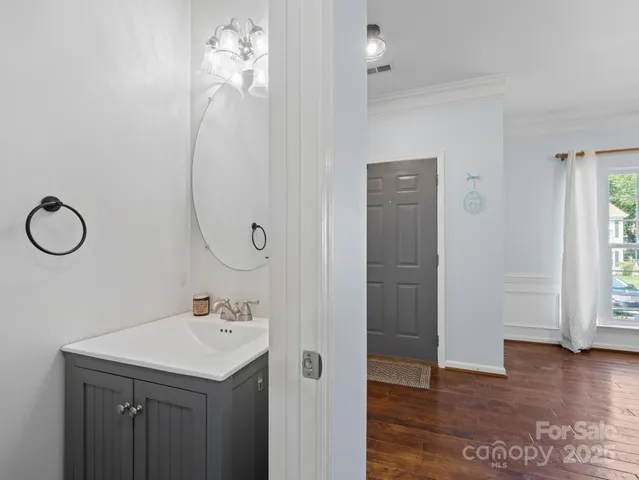 a bathroom with a sink a mirror and a window