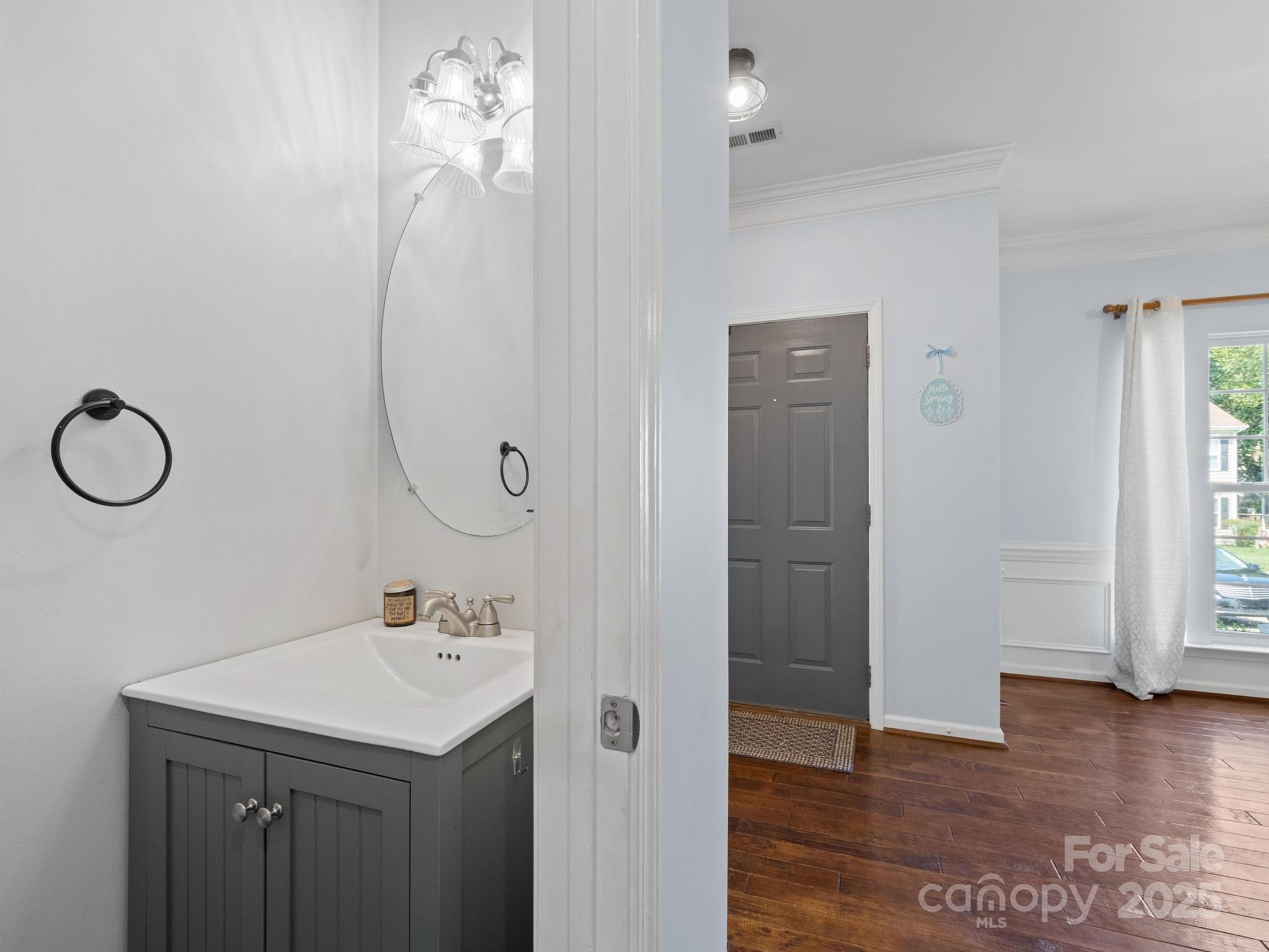 5535 Whispering Wind Lane Indian Trail, NC 28079 - Photo 5 of 25 a bathroom with a sink a mirror and a window