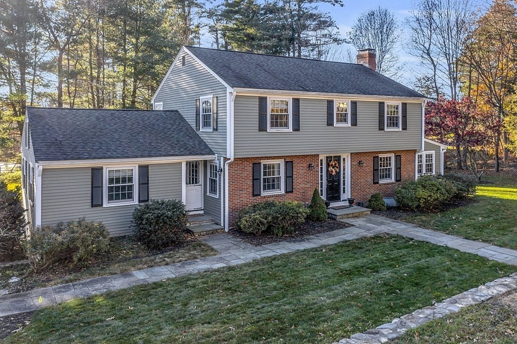 a aerial view of a house next to a yard