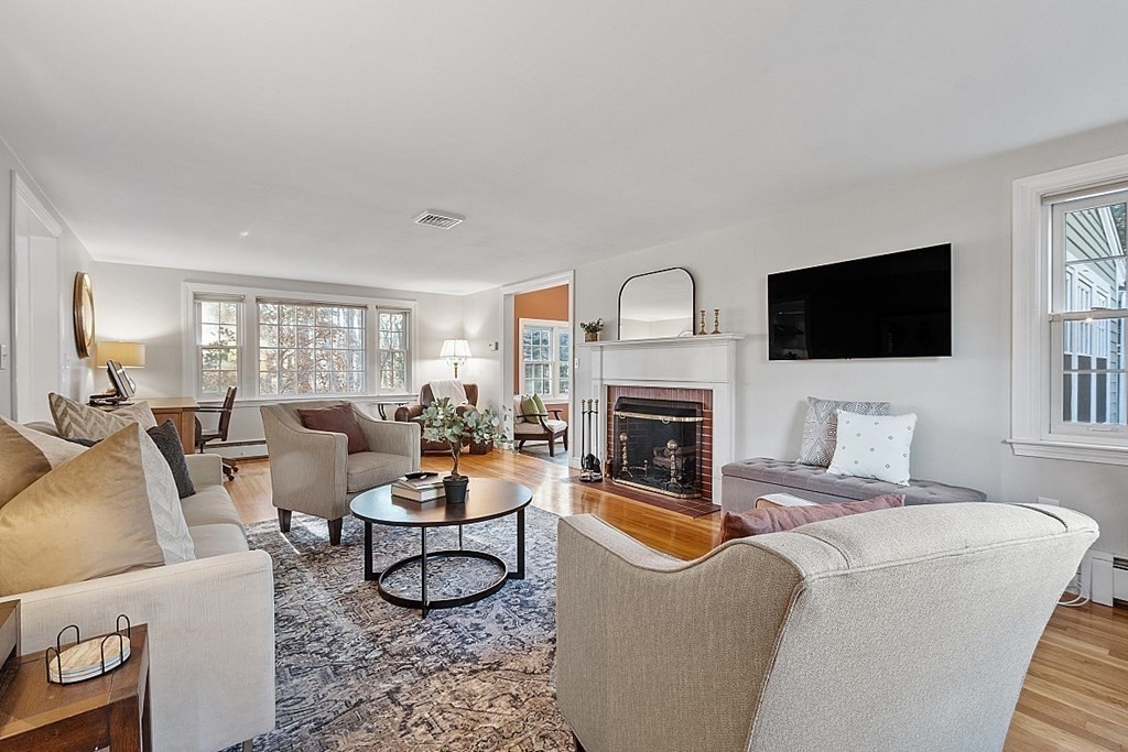 2 Joseph Reed Lane Acton, MA 01720 - Photo 12 of 42 a living room with furniture a fireplace and a flat screen tv