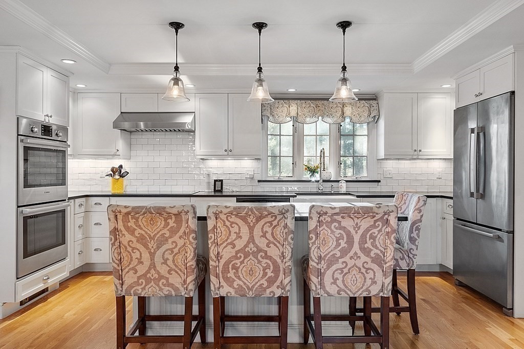 2 Joseph Reed Lane Acton, MA 01720 - Photo 3 of 42 a kitchen with stainless steel appliances a dining table chairs refrigerator and sink