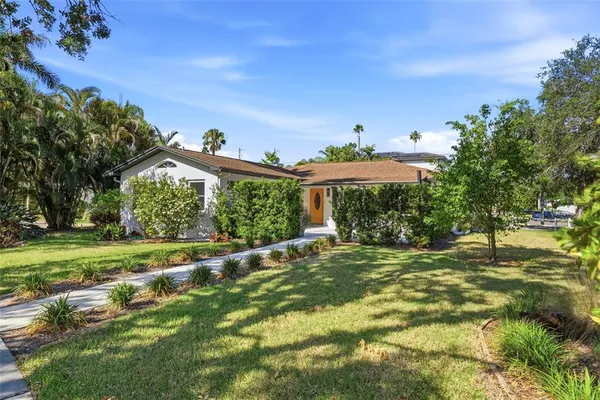 a big yard with lots of green space and road view