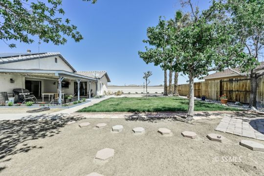 1260 Arroyo Street Ridgecrest, CA 93555 - Photo 42 of 44 a front view of a house with a garden and patio