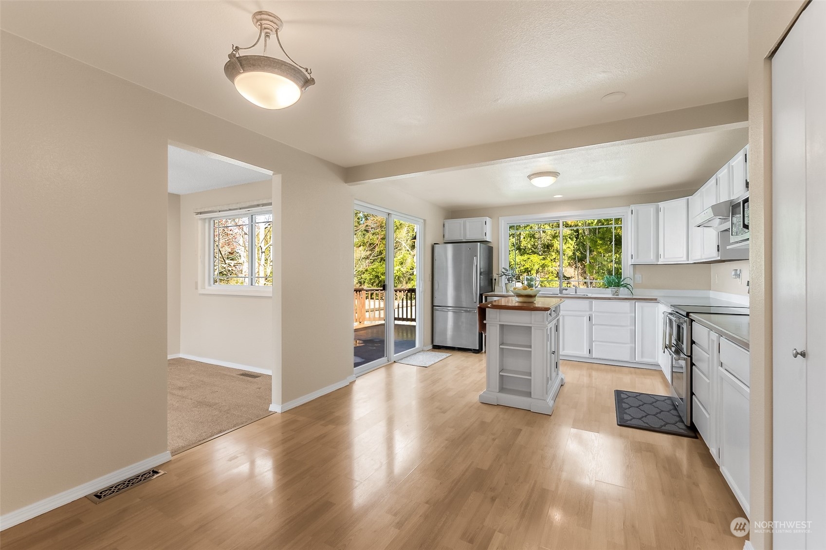 4320 Northeast 24th Street Renton, WA 98059 - Photo 8 of 34 a kitchen with white cabinets and stainless steel appliances