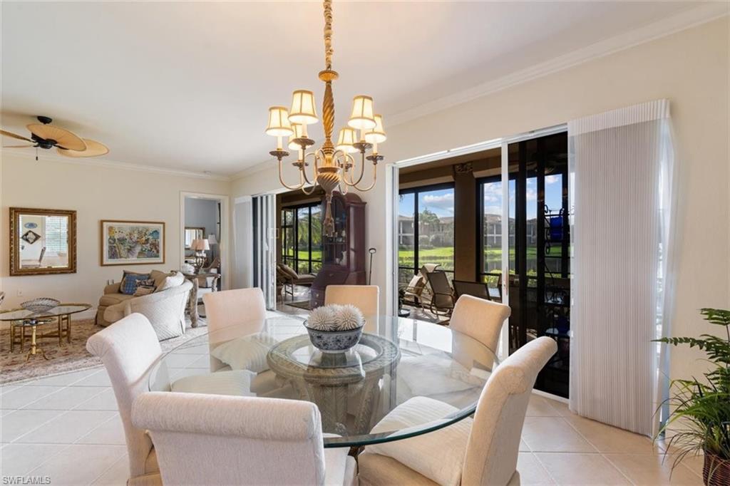 821 Regency Reserve Circle, Unit 3802 Naples, FL 34119 - Photo 13 of 26 a view of a dining room with furniture wooden floor and chandelier