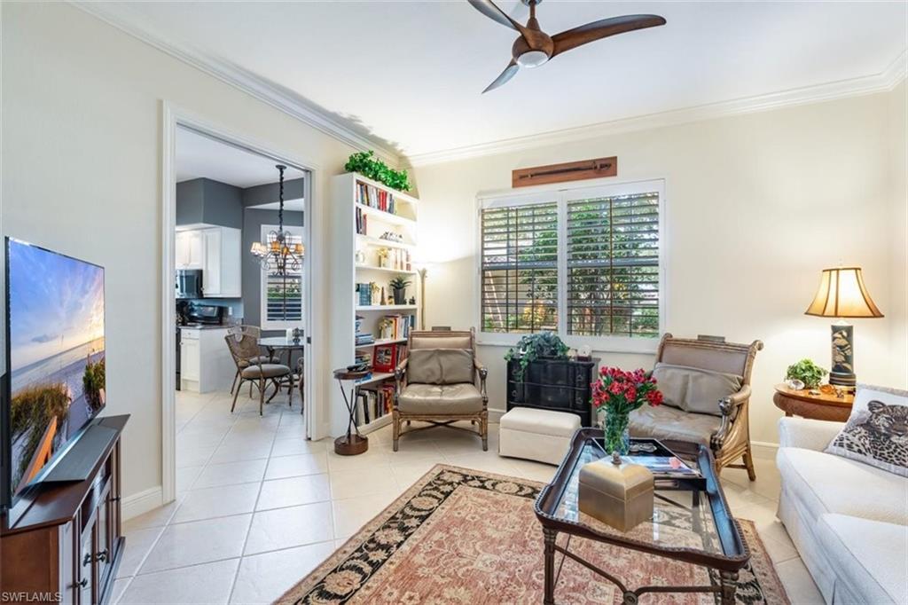 821 Regency Reserve Circle, Unit 3802 Naples, FL 34119 - Photo 4 of 26 a living room with furniture and a large window