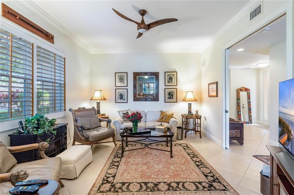 821 Regency Reserve Circle, Unit 3802 Naples, FL 34119 - Photo 5 of 26 a living room with furniture and wooden floor