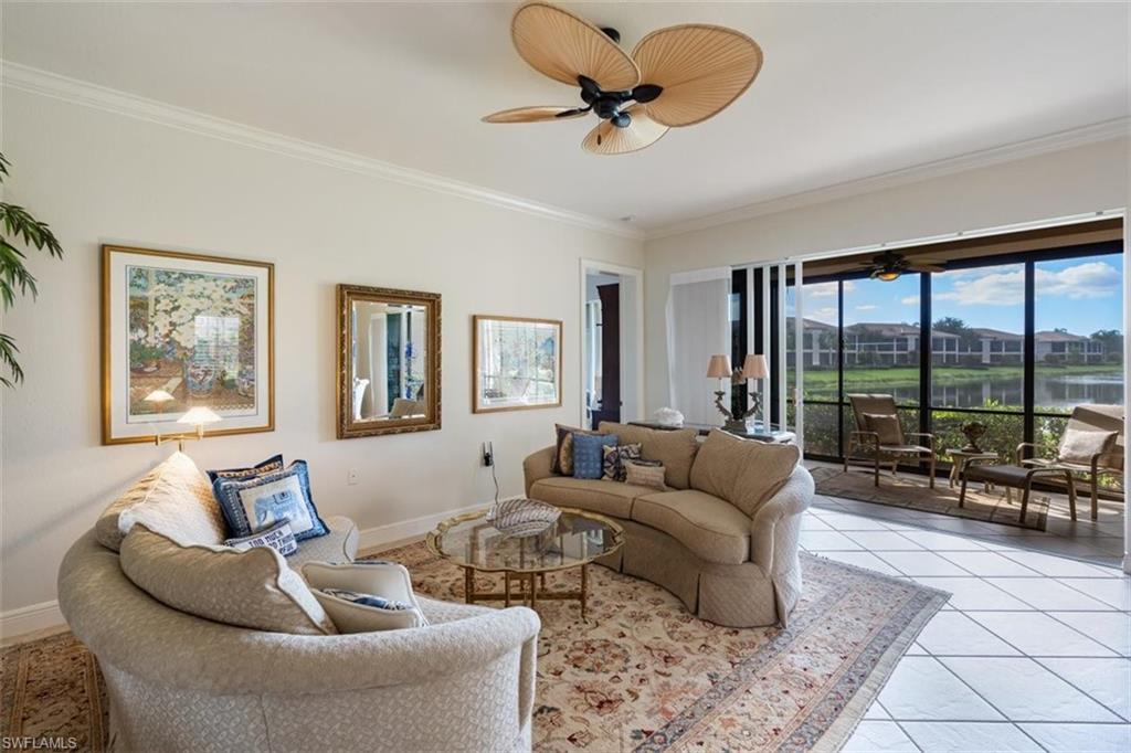 821 Regency Reserve Circle, Unit 3802 Naples, FL 34119 - Photo 10 of 26 a living room with furniture and a large window