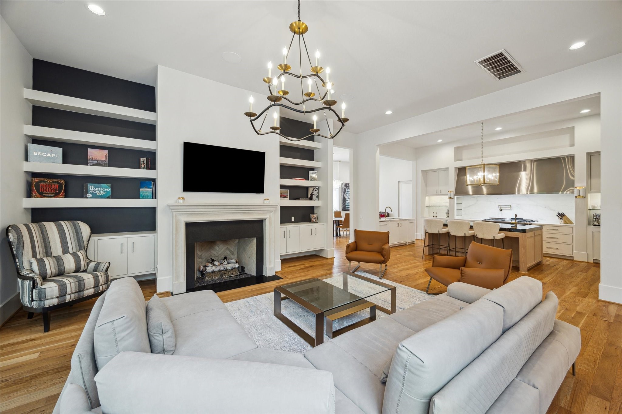22 East Shady Lane, Unit E Houston, TX 77063 - Photo 13 of 50 a living room with furniture a fireplace and a flat screen tv